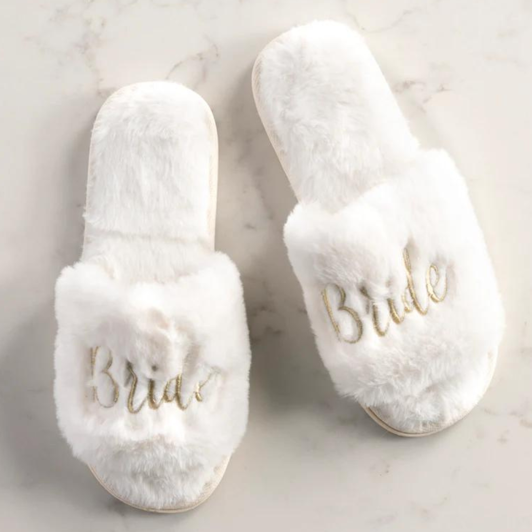 Ivory White Faux Fur and Gold Embroidery Script Bride Slippers on Marble Background