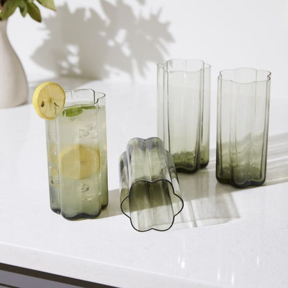 4 Sonnet Smoky Green Modern Floral Shaped Highball Cocktail Drinking Glasses, one tipped over, one filled with lemon cocktail