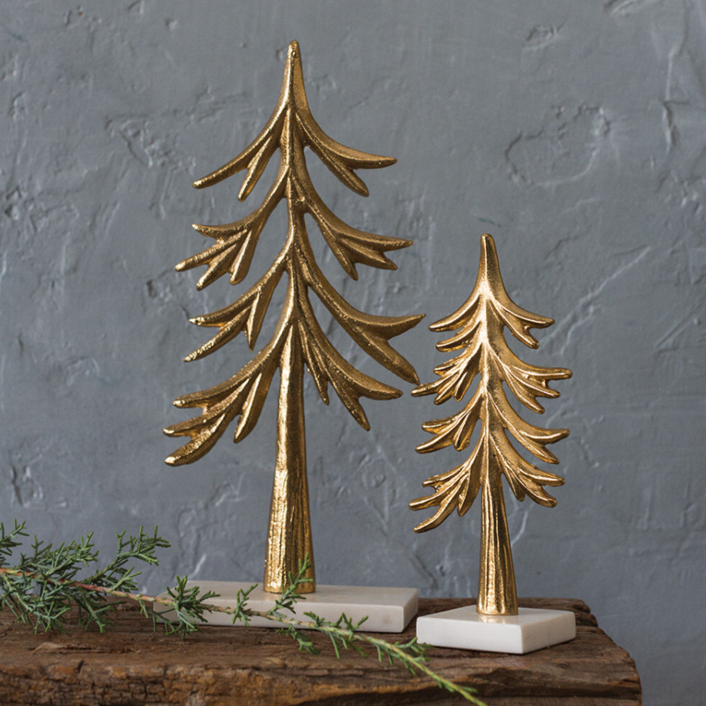 The Gilded Balsam Tree, a airy balsam-like design in metal with a gilded gold finish and a marble base, perfect for holiday tabletop decor, available in two sizes.