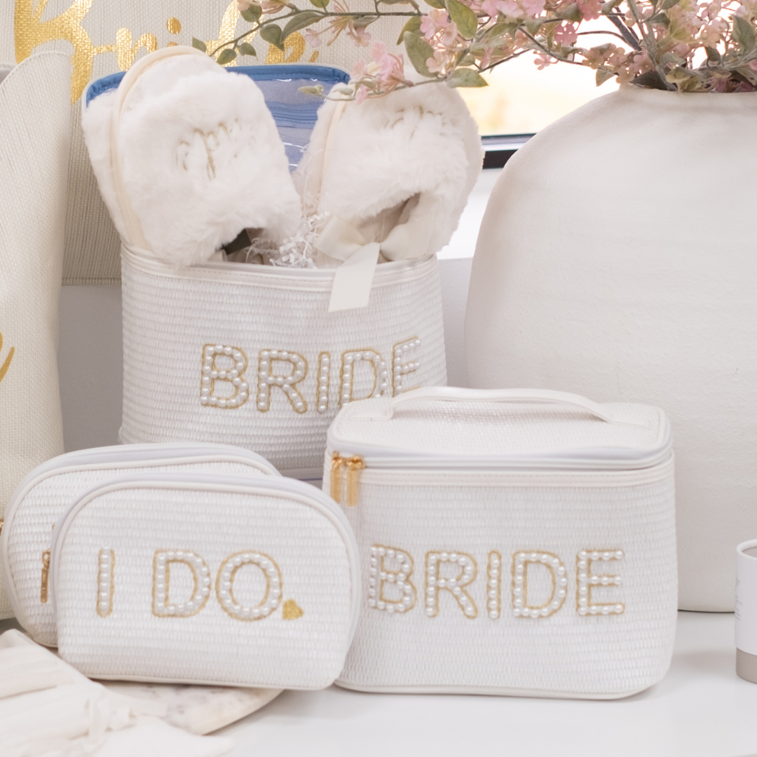 For The Bride Collection Cosmetic Case, Zipper Pouch, Slippers, Styled Next to White Vase and Pink Florals
