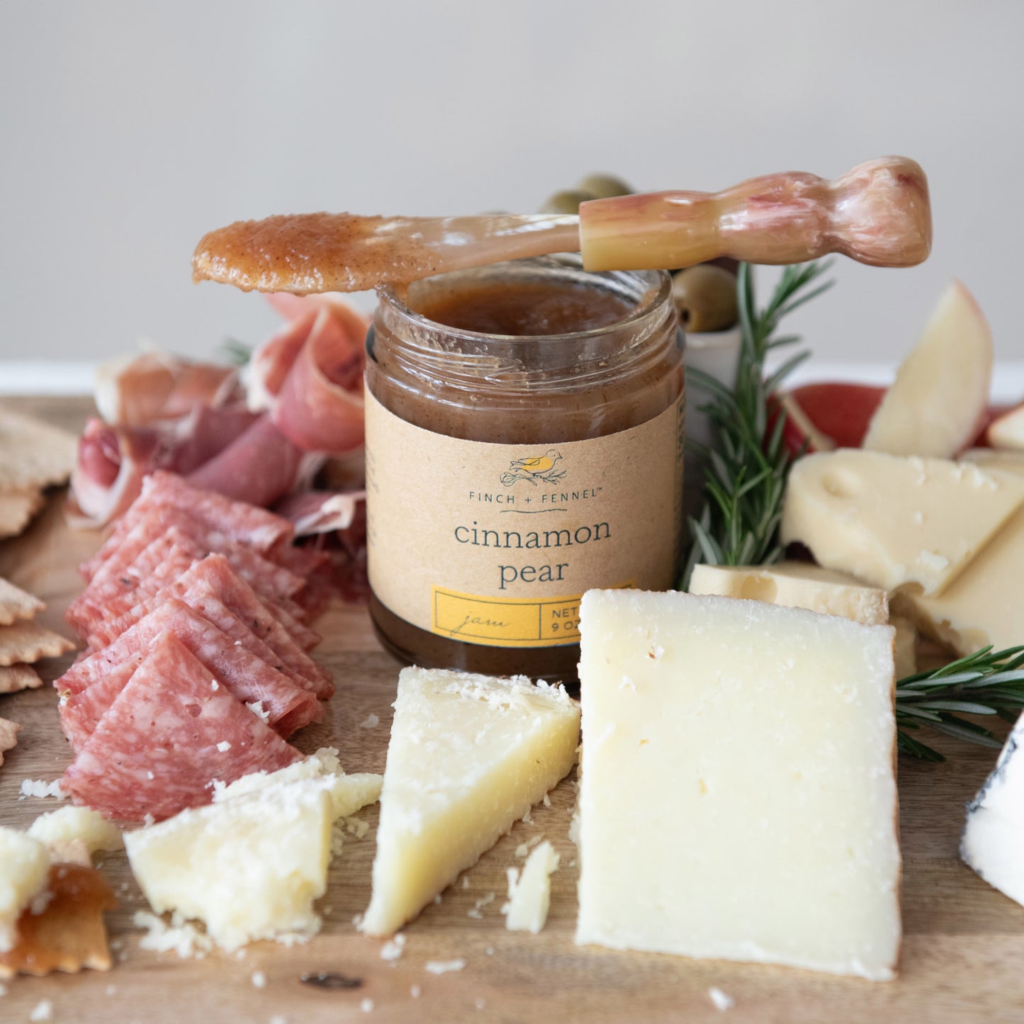 Giftable Gourmet Spiced Cinnamon Pear Jam Spread paired with Cured Meats, Cheeses, and Herbs on Charcuterie Board