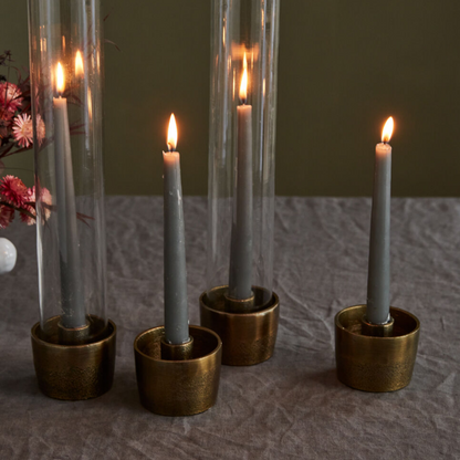 Estoria 4-Piece Round Modern Cast Aluminum Antiqued Gold Finish Taper Candle Holder Set styled for Tablescape with Cylinder Glass Candle Sleeve