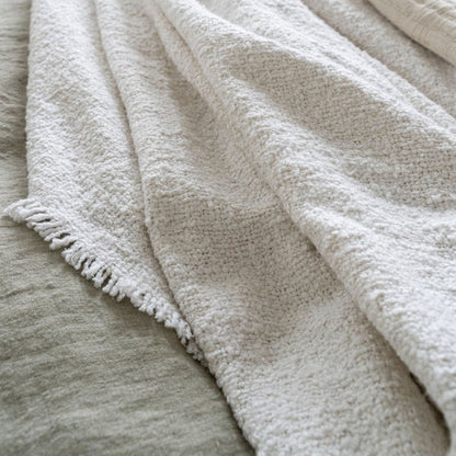 Montero Boucle Woven Bed Blanket with Fringed Edges in Classic Cream White Color Styled Draped on Bed to Show Texture