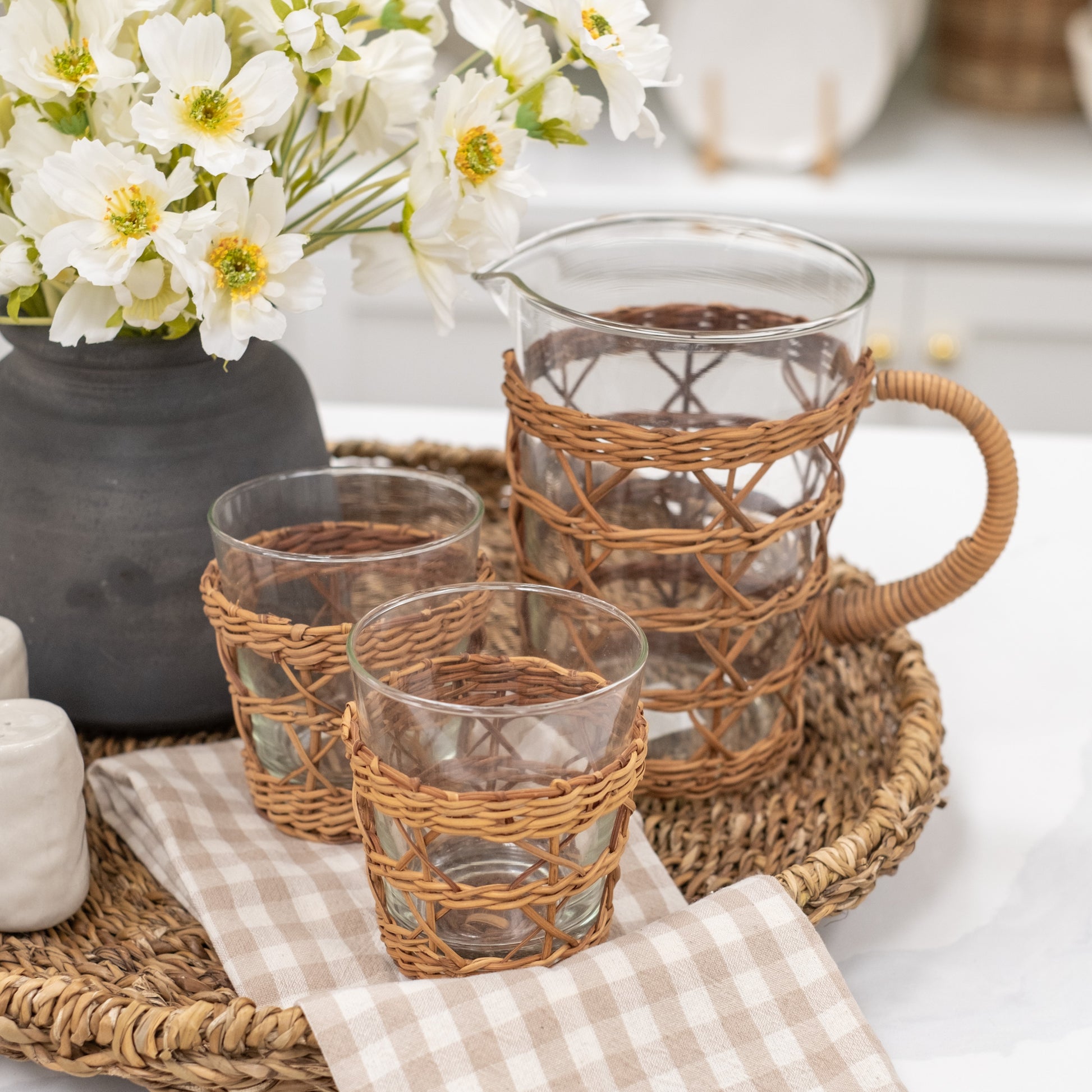 Caged Tan Rattan Wrapped Glass Pitcher and Drinkware styled on tray for Summer